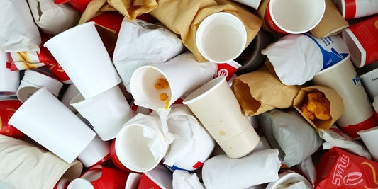Fast food wrappers and containers piled up.